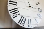 Simple White Lightly Distressed Large Wall Clock with Black Roman Numerals (in stock)