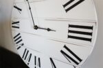 Simple White Lightly Distressed Large Wall Clock with Black Roman Numerals (in stock)
